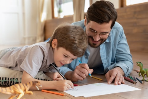 A parent and online student working on an assignment. 