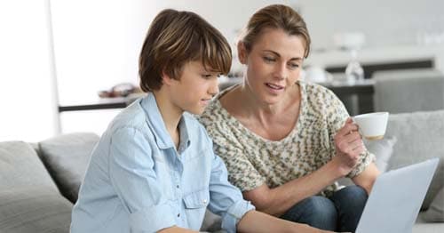 An online student working with their learning partner learning about basic computer skills.