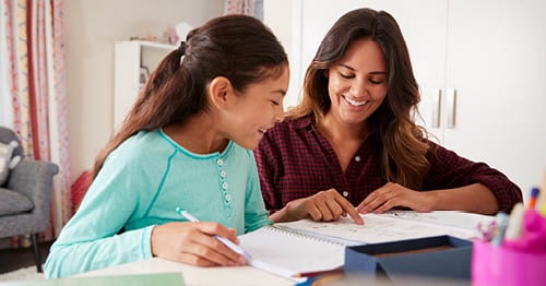 A parent and her student reviewing course load as part of good habits for at-home school.