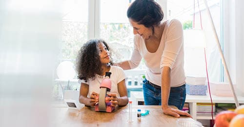 A Learning Coach helping her online student with a science fair project.