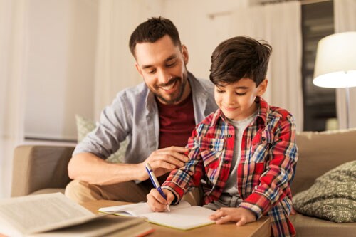 A parent and child work on an online school assignment together