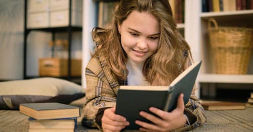 An online student reading a book