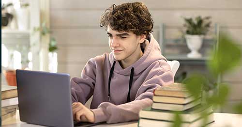  An online student at his desk to go back to school online