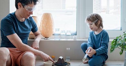 A parent taking part in his student’s education by helping with a science project.