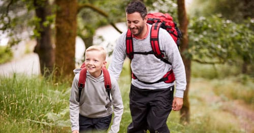 A working parent taking time off to go on a hiking field trip.