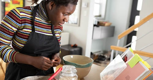 An online school student meal-prepping a healthy breakfast.