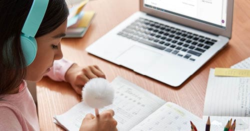 An online elementary school student, working through math problems with critical thinking skills.