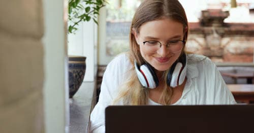 A student enrolled in online distance learning using a laptop. 