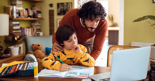 Father helping his son with his homework at home