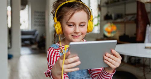 An online school student studying with a language immersion program on a tablet. 