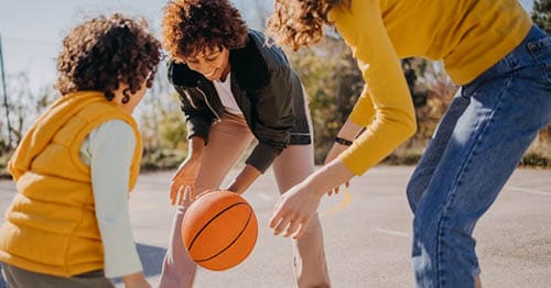 A family playing sports as part of a summer hobby for teens. 