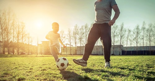 A family plays soccer together. 