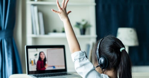 A student participating in an online school lesson.