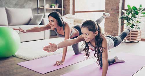 A parent and child practicing yoga.  