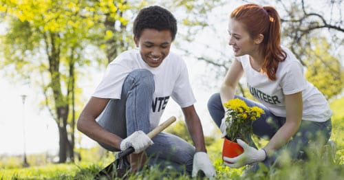 Online high school students who are part of the National Honor Society volunteering in a community garden.  