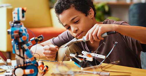 Young middle school student taking part in a STEM activity. 