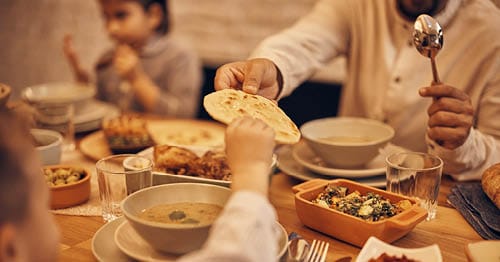 A Connections Academy family enjoying an Indian dinner together.
