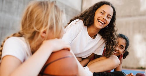 A team of online school students forming student connects by playing basketball together. 