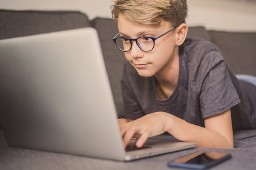 Homeschool student learns computer coding skills.