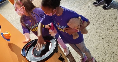 Young students playing drums on a field trip