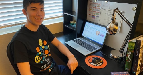 A high school student sitting at his desk