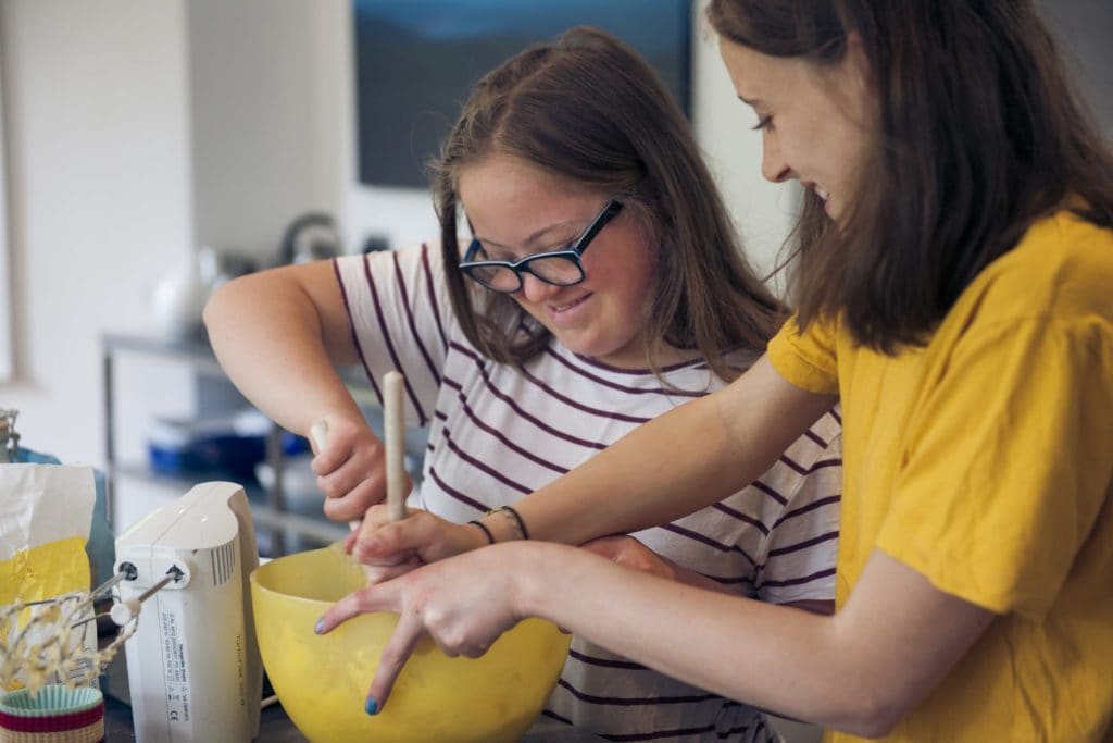 A parent and child prepare healthy brain food for kids