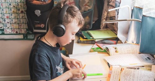 Young elementary sudent learning at his desk