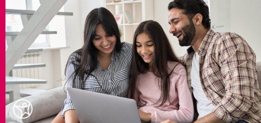 Parents helping their child with an online school assignment.