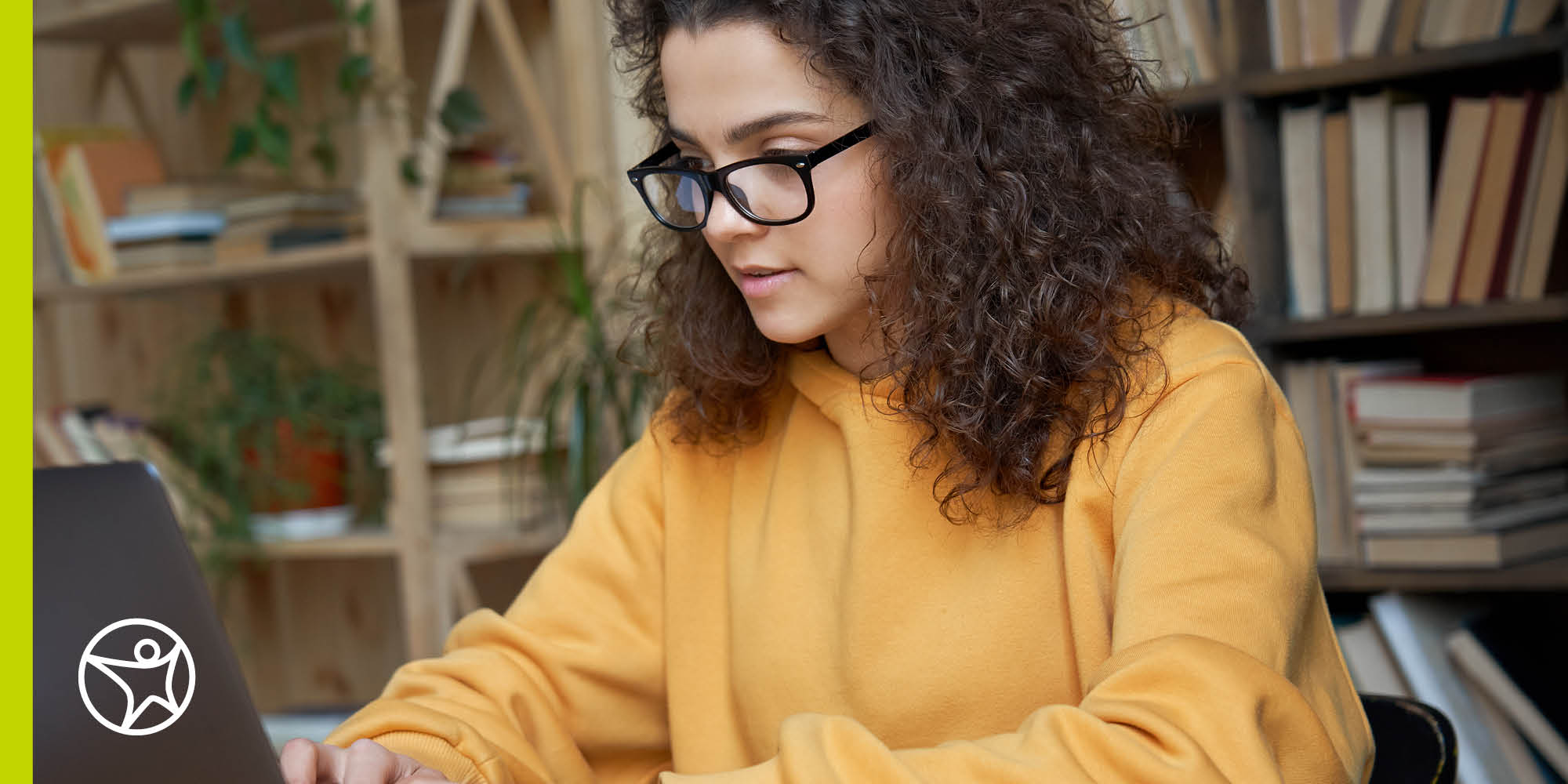 A teenager girl is typing on a laptop