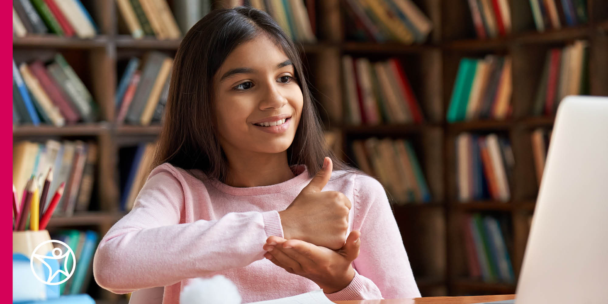 middle school girl giving thumbs up to computer