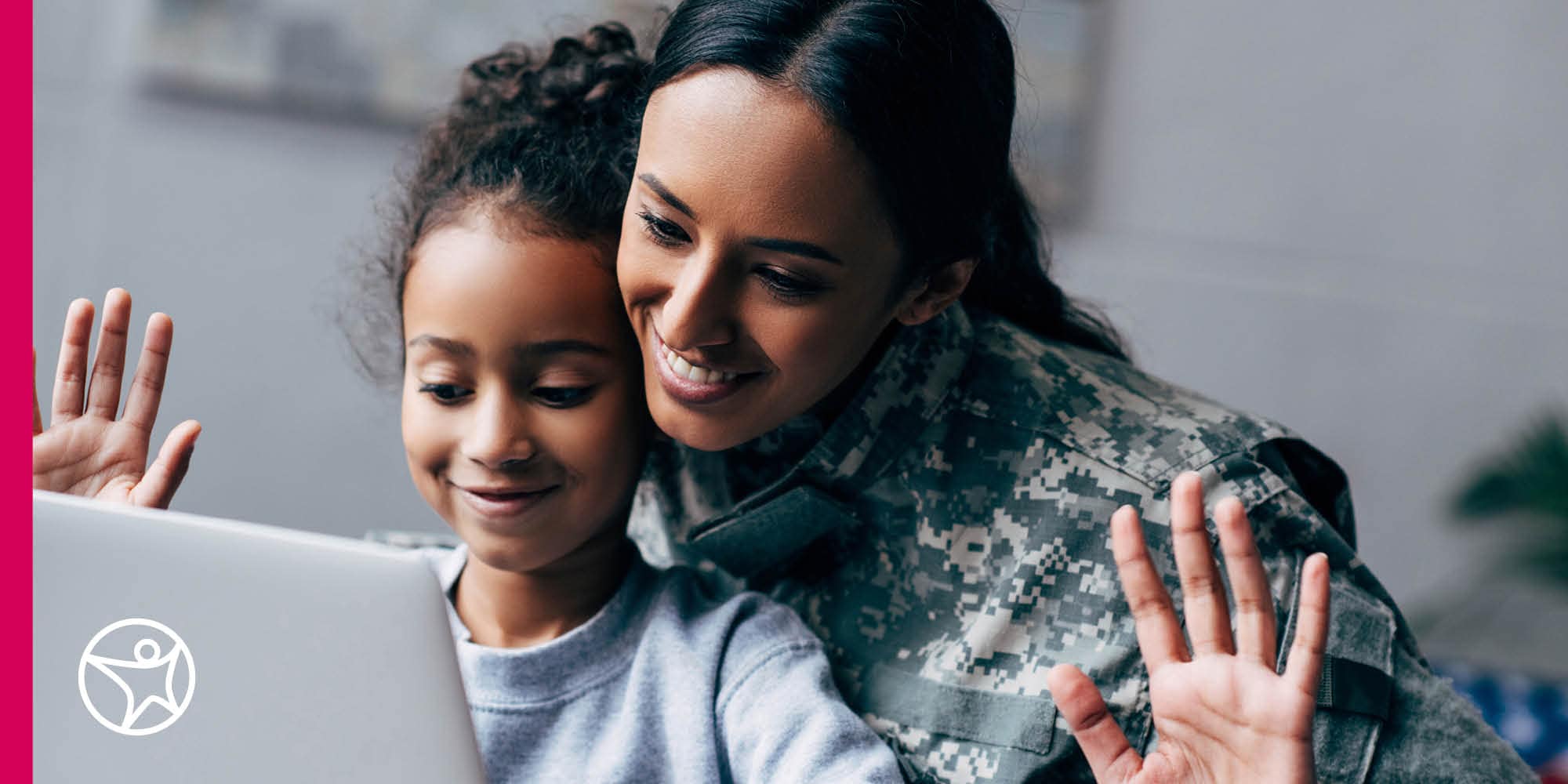 military mom and young daughter waving at laptop