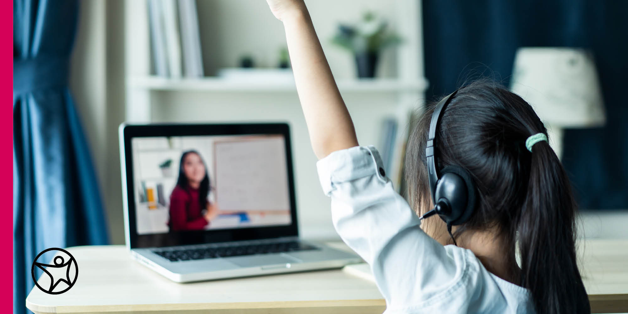 A young girl is raising her hand during an online class