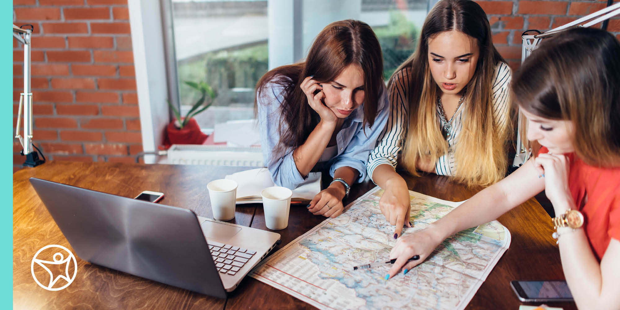 three young women looking at a map