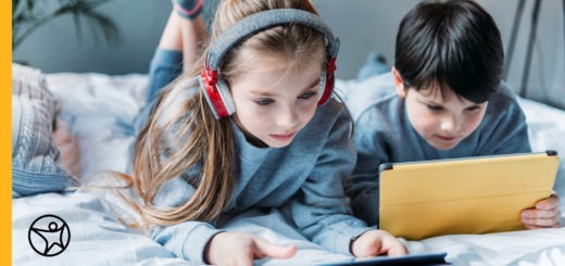 Two elementary school kids doing online work on their tablets