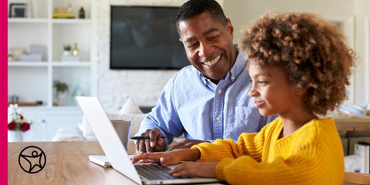 A dad is helping his daughter with school work