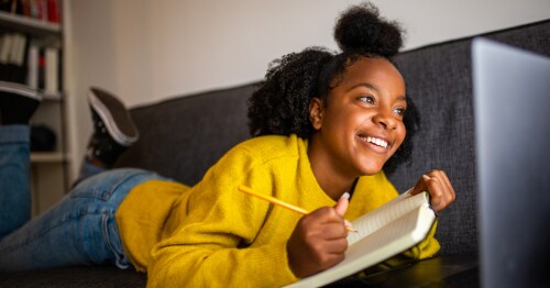 A girl writing her own story for fun light summer reading