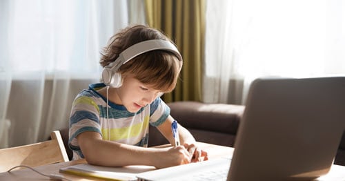 Elementary school student completes beginner typing game on computer