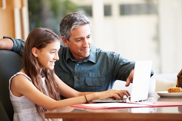 Father helping Daughter with schoolwork